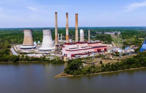 exterior of plant and stacks along a river