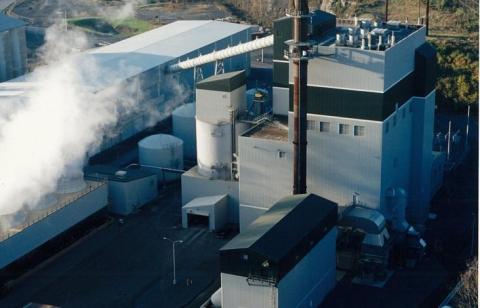 exterior of grey colored northampton plant with steam coming from stacks